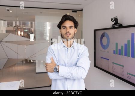Serious ambitious young business project leader man posing in office Stock Photo