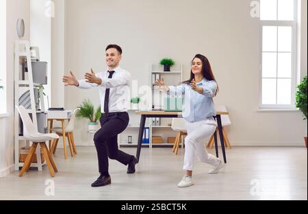 Office yoga, businessman, businesswoman doing fitness workplace in squat pose, happy meditating  Stock Photo
