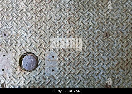 Detail of a weathered steel anti-slip metal plate on a floor Stock Photo