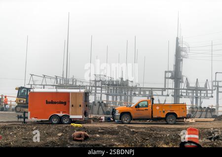 Columbus, USA - November 3, 2022: Electricity electric power transmission station substation with construction site workers by cable wires Stock Photo