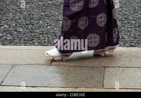 A Japanese Shinto priest in kimono wearing traditional wooden geta sandals with white "tabi" split-toe socks which are still in fashion in Japan. Stock Photo