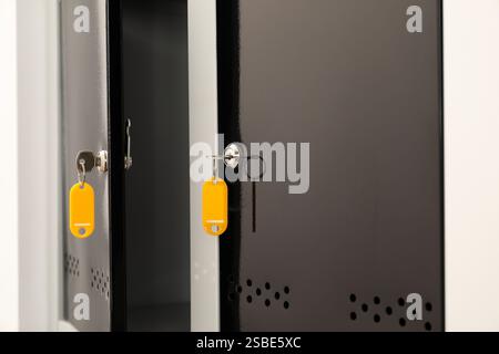 Modern lockers with bright keys indoors, closeup Stock Photo