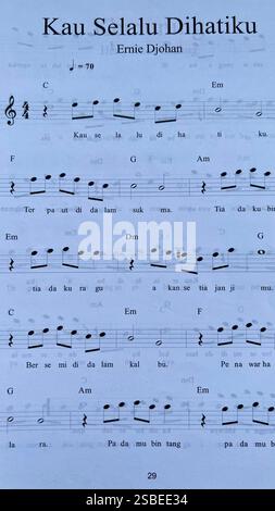 Handwritten Music Notebook with Musical Notation, Chords and Song Lyrics Stock Photo