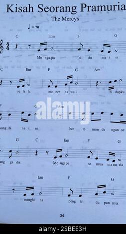 Handwritten Music Notebook with Musical Notation, Chords and Song Lyrics Stock Photo