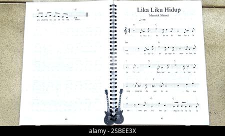 Handwritten Music Notebook with Musical Notation, Chords and Song Lyrics Stock Photo