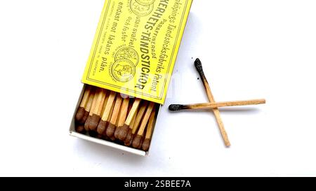 Jakarta, 2 febuary 2025. Opened matchbox with two used matches placed outside, isolated on a white background. A simple minimalistic design. Stock Photo