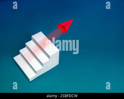 Red paper plane flying over white steps as bar graph chart, isolated on blue background with copy space. Business growth plan, startup, leadership, mi Stock Photo