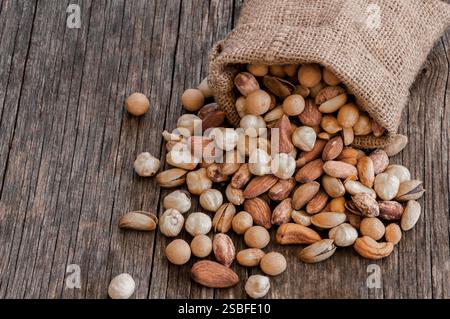 xed Nuts, dried fruits on rustic table, different kind of healthy food Stock Photo