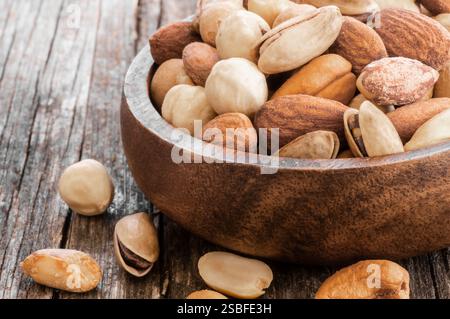 xed Nuts, dried fruits on rustic table, different kind of healthy food Stock Photo