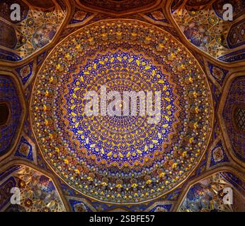 A stunning view of an intricately designed dome featuring geometric patterns and vibrant colors, showcasing a blend of blue, gold, and intricate tile Stock Photo
