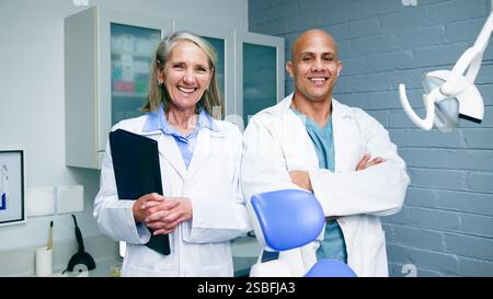 Two Confident Dentists Smiling in their Modern Clinic Stock Photo