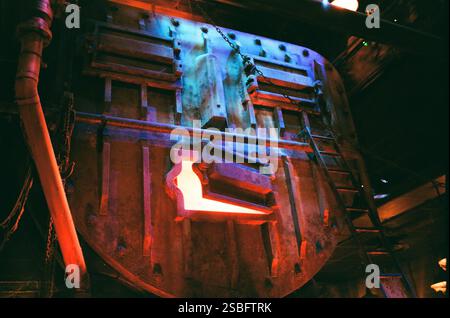 Industrial furnace door glowing with intense red-orange heat. Stock Photo