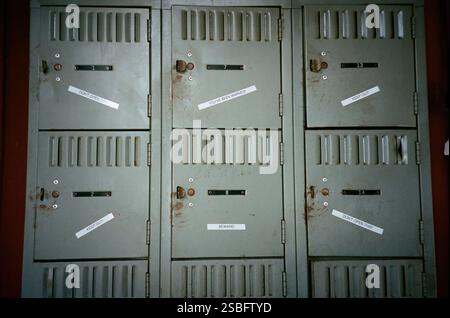 Rusty metal lockers with warning labels like "Keep Out" and "Beware." Stock Photo
