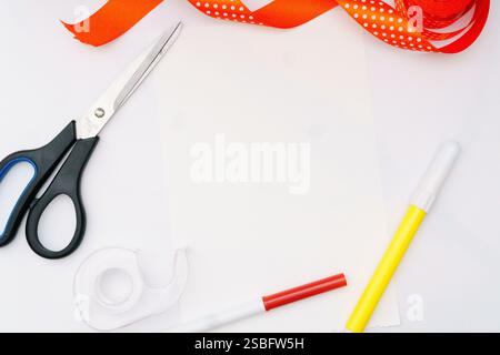 Craft supplies arranged on a white background for a DIY project. Stock Photo