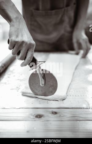 Artisan Baker Cuts Pastry Dough Stock Photo