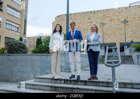 Business team using smartphone and discussing work in urban setting Stock Photo