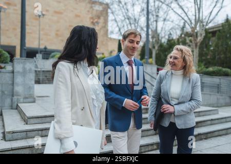 Businesspeople walking and talking on city steps Stock Photo