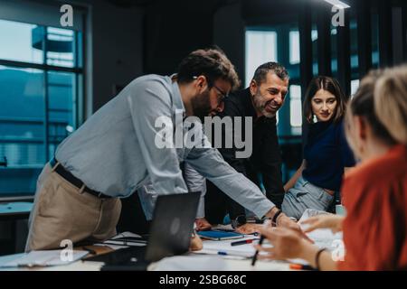 Multiracial team collaborating on a creative business project Stock Photo