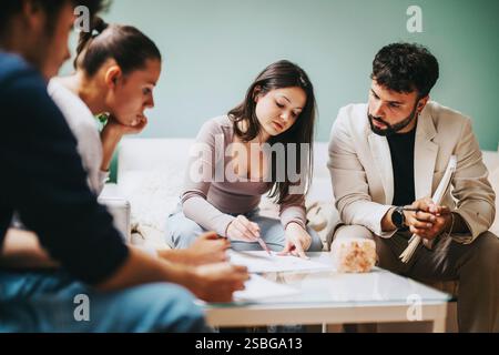 High school students collaborating on projects with professor after school Stock Photo