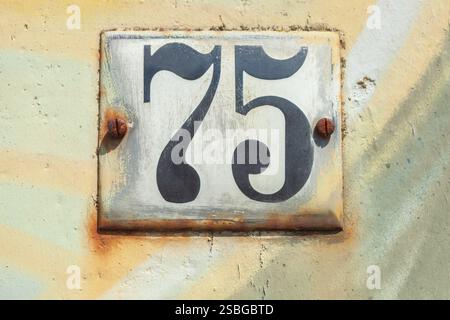 Old house license plate number 75 on house wall, Germany Stock Photo