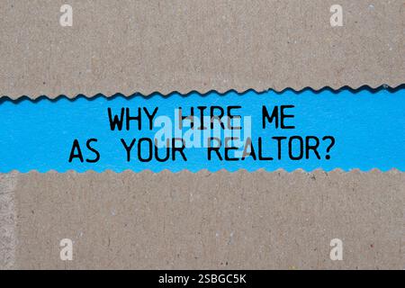 Why hire me as your realtor message written on ripped torn paper on blue background. Conceptual why hire me as your realtor symbol. Copy space. Stock Photo
