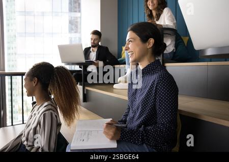 Diverse groupmates take part in educational class seated in auditorium Stock Photo