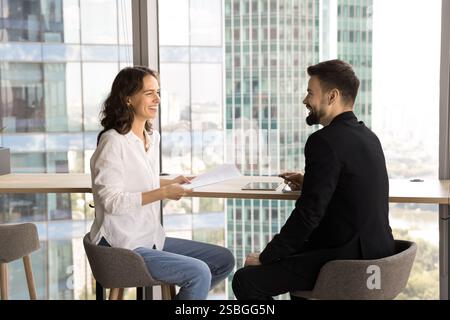 Two teammates discussing joint task, collaborating on project in office Stock Photo