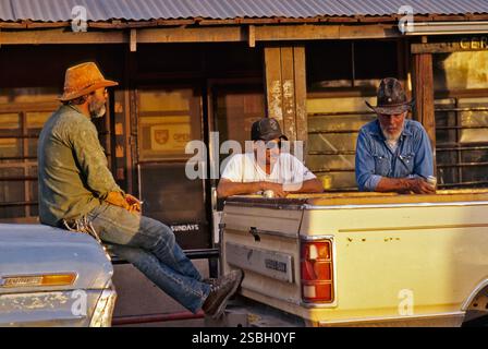 Local men in town center, drinking beer, talking, Los Cerrillos, The Turquoise Trail, New Mexico, USA Stock Photo
