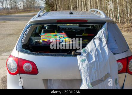 Rear window of a car smashed due to vandalism symbol image Stock Photo