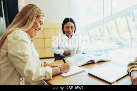 A diverse group of students studying happily in a city school setting. This image highlights education, collaboration, and a positive learning atmosph Stock Photo