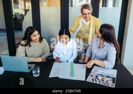 College students and their professor actively participate in a classroom learning session, promoting collaboration and engagement in an educational se Stock Photo