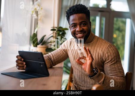 Freelancer using digital tablet to communicate online. Stock Photo
