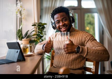 Freelancer using digital tablet to communicate online. He is sitting in bar and having video call. Stock Photo