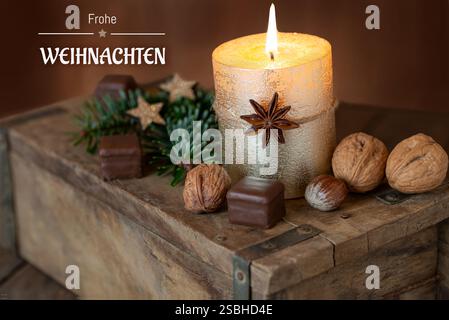 Christmas card with candle and German text Merry Christmas Stock Photo