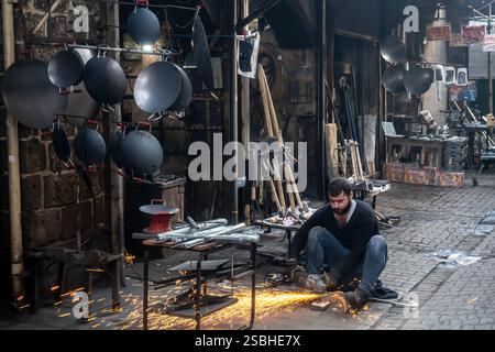 metal works welder, craftsman in his workshop, metal pots, Diyarbakır Turkey Turkiye Stock Photo