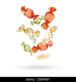 Candies in bright wrappers falling on white background Stock Photo