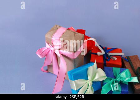 Blue, red, brown gift boxes with bows on a blue paper background. Stock Photo