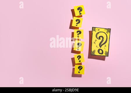 Quiz card with question marks on pink background Stock Photo
