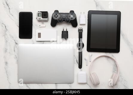 Set of different modern gadgets with laptop on light background Stock Photo