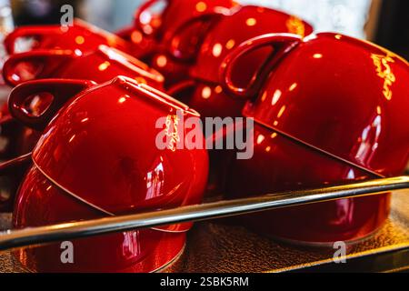 Many transparent glass glasses and red ceramic cups on a shelf in a cafe. Selected focus. High quality photo Stock Photo