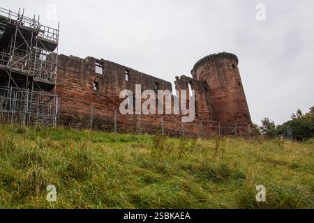 Ruins of Medieval Bothwell Castle, South Lanarkshire, Scotland.  Scaffolding against part of red sandstone wall for maintenance and reconstruction. Stock Photo