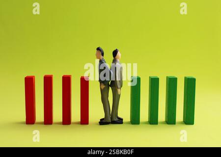 Two executives going in opposite directions with row of goals Stock Photo