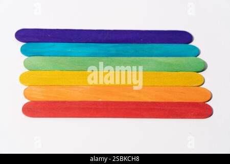 Colorful Wooden Sticks in Rainbow Order on White Background Stock Photo