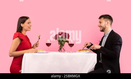 Happy Couple Dating Having Romantic Dinner Sitting Over Yellow Background Stock Photo