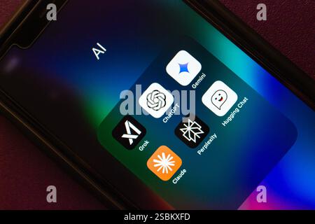 Grok AI, ChatGPT, Google Gemini, Claude, Perplexity, and Hugging Chat apps are shown on an iPhone. Modern generative AI chatbot service concept image. Stock Photo