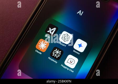 Grok AI, ChatGPT, Google Gemini, Claude, Perplexity, and Hugging Chat apps are shown on an iPhone. Modern generative AI chatbot service concept image. Stock Photo