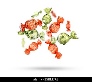 Candies in bright wrappers falling on white background Stock Photo
