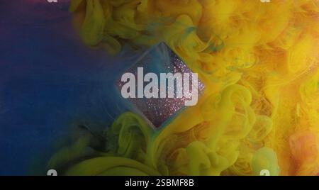 Mixing tone. Color spill splash. Bright yellow blue flow smoke glitter purple cube cloud paint ink mist texture on abstract art light background. Stock Photo