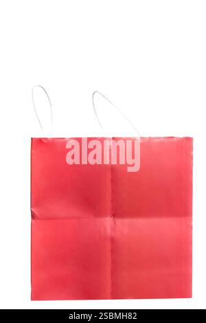 Bright red shopping bag made of paper with white rope handles displayed against a white background. perfect choice for festive occasions, gifting, or Stock Photo