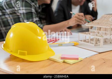 Architectural equipment at construction site! Data working and tablet laptop. Architect explaining project plan to clients. Confident businesswoman ho Stock Photo